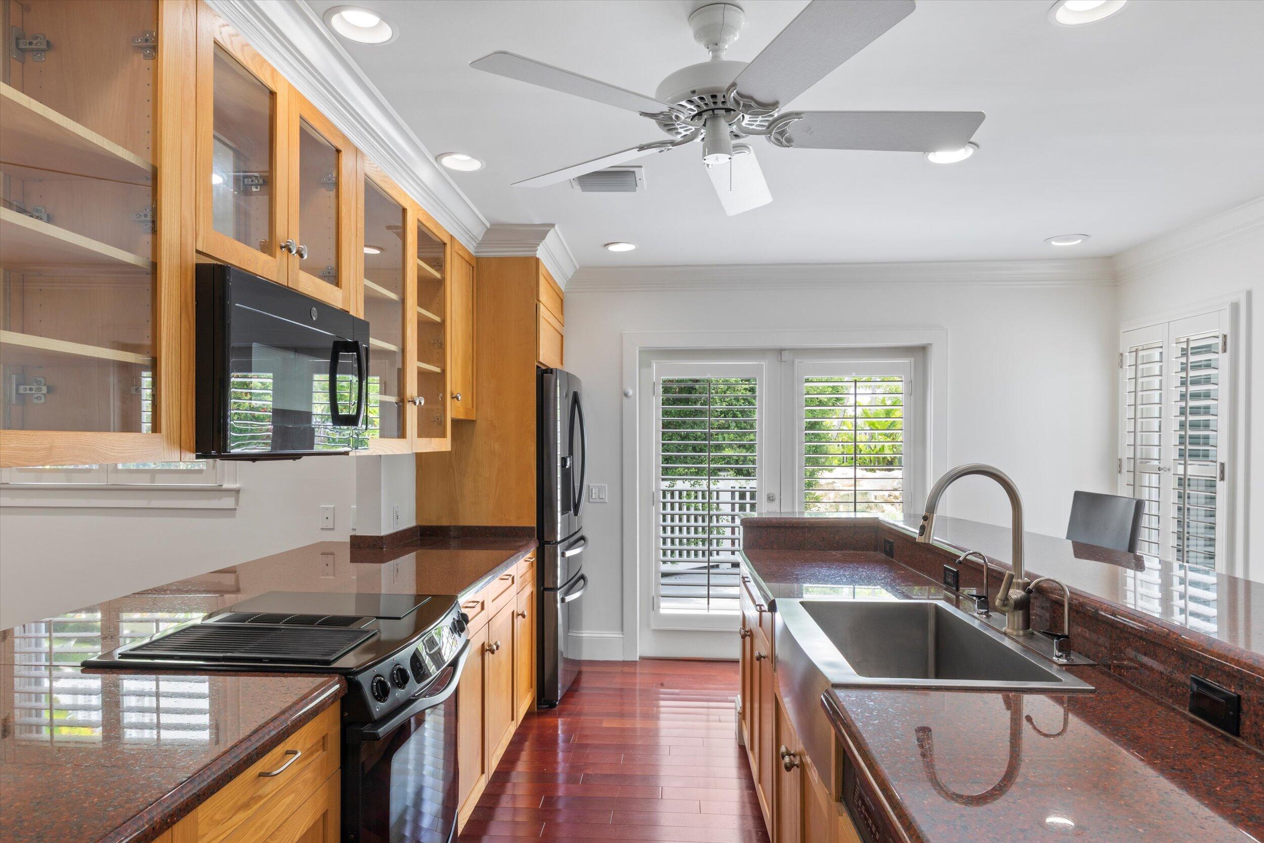 413 Emma Street, Unit A Key West, FL 33040 - Photo 22 of 64 a kitchen with granite countertop a stove a sink and a refrigerator