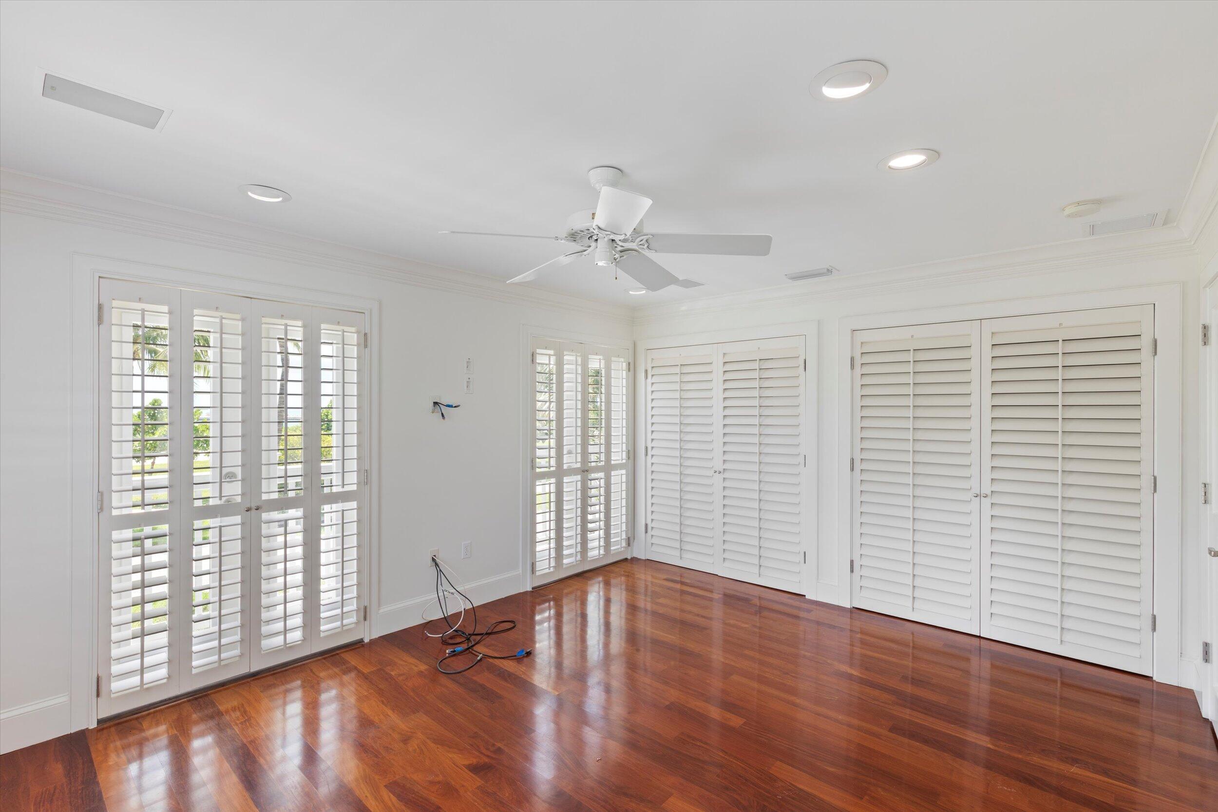 413 Emma Street, Unit A Key West, FL 33040 - Photo 32 of 64 a view of an empty room with wooden floor and a window
