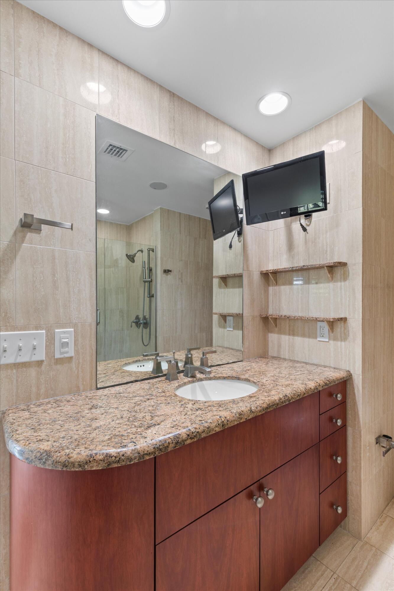 413 Emma Street, Unit A Key West, FL 33040 - Photo 36 of 64 a bathroom with a granite countertop sink and a mirror