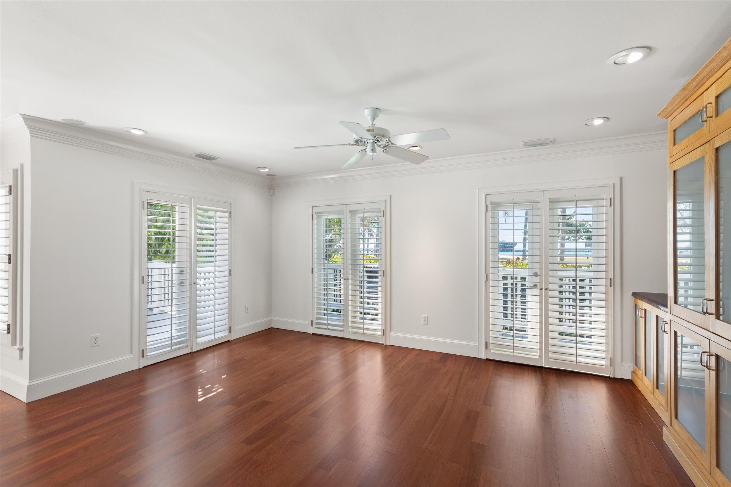 413 Emma Street, Unit A Key West, FL 33040 - Photo 8 of 64 a view of an empty room with wooden floor and a window