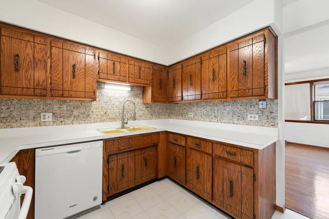 a kitchen with a sink cabinets and window