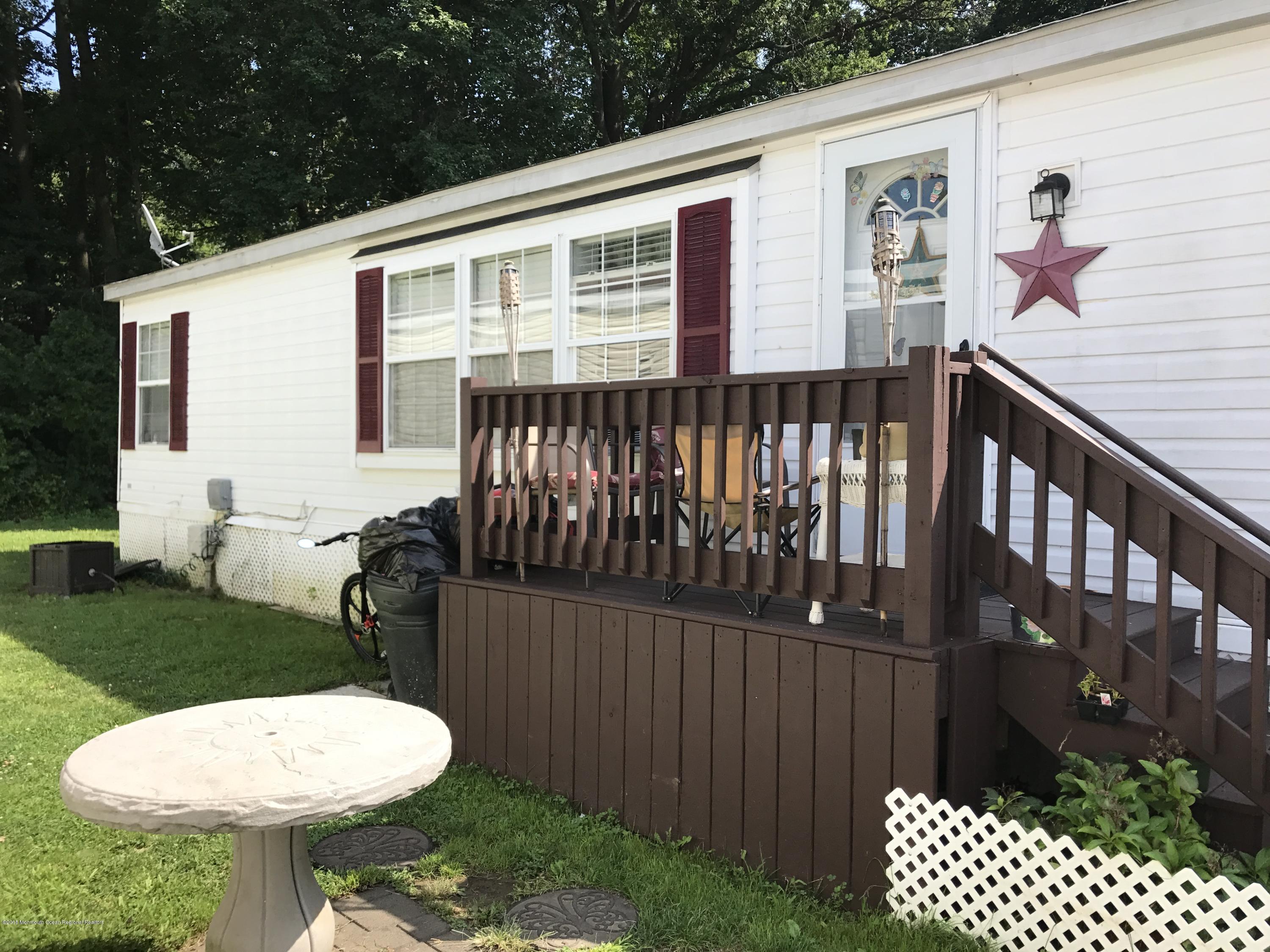 1272 Highway 36, Unit 39 Hazlet, NJ 07730 - Photo 1 of 13 a view of a chair and table in backyard