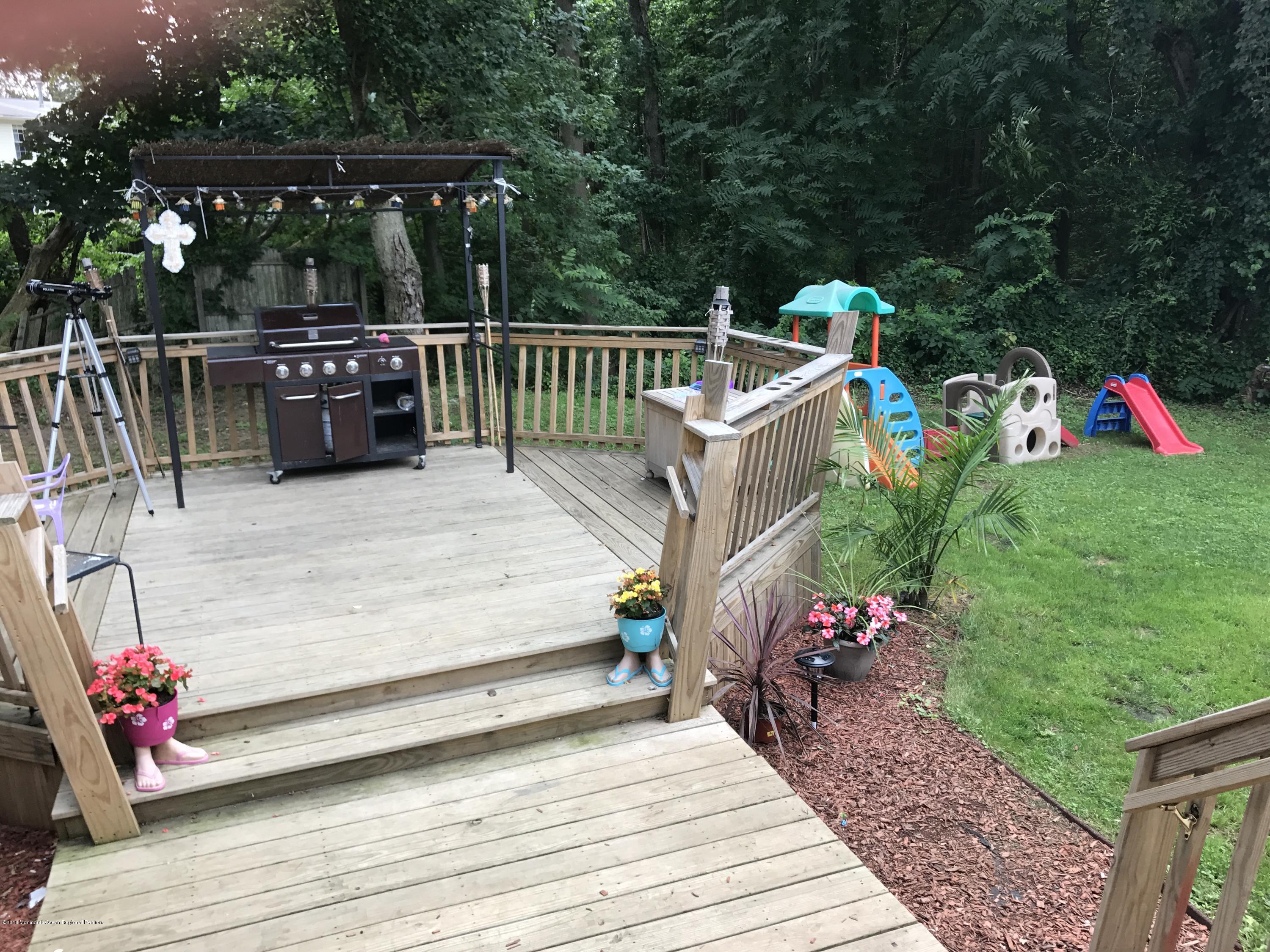 1272 Highway 36, Unit 39 Hazlet, NJ 07730 - Photo 11 of 13 a view of table and deck