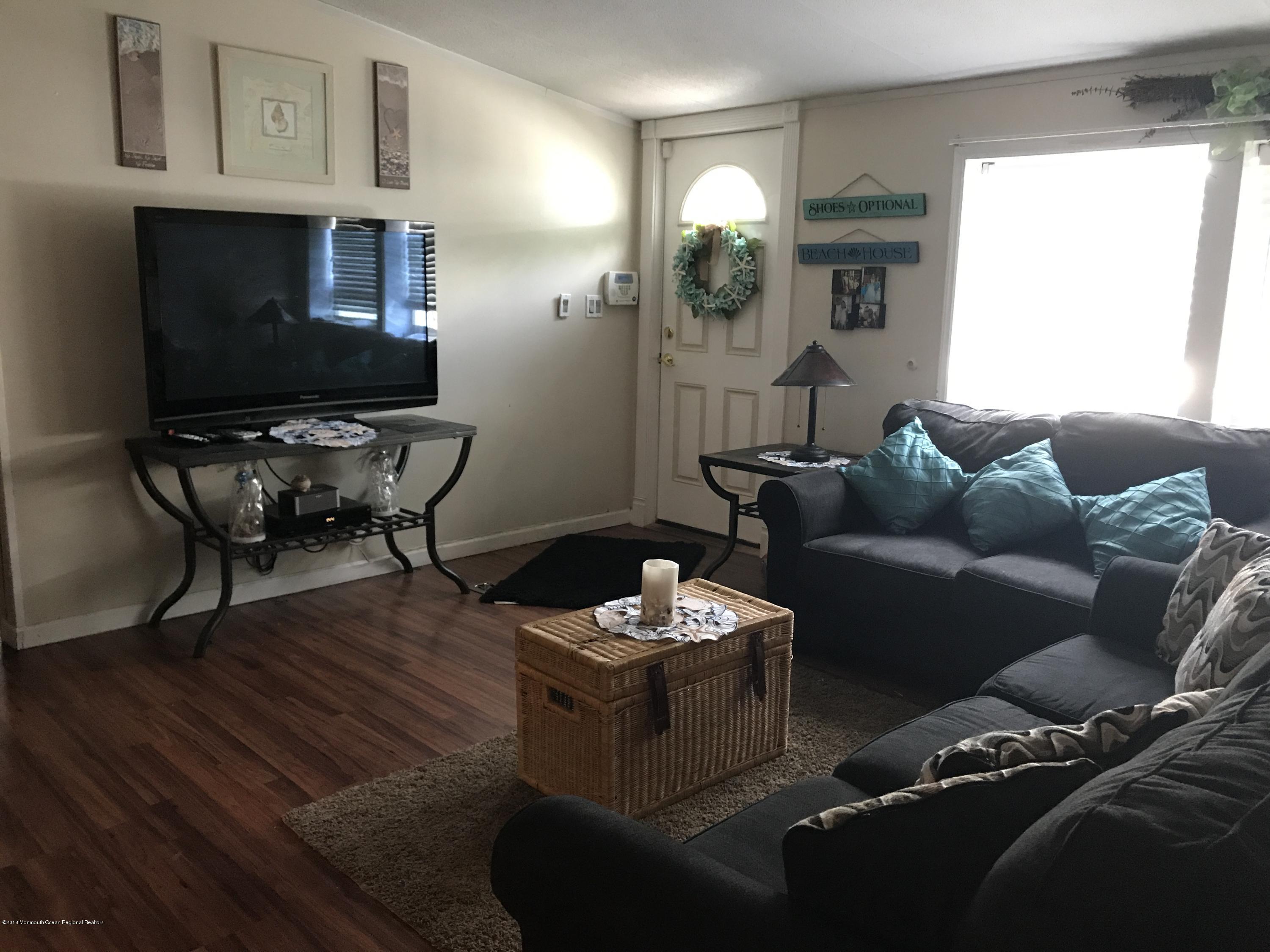 1272 Highway 36, Unit 39 Hazlet, NJ 07730 - Photo 2 of 13 a living room with furniture and a flat screen tv