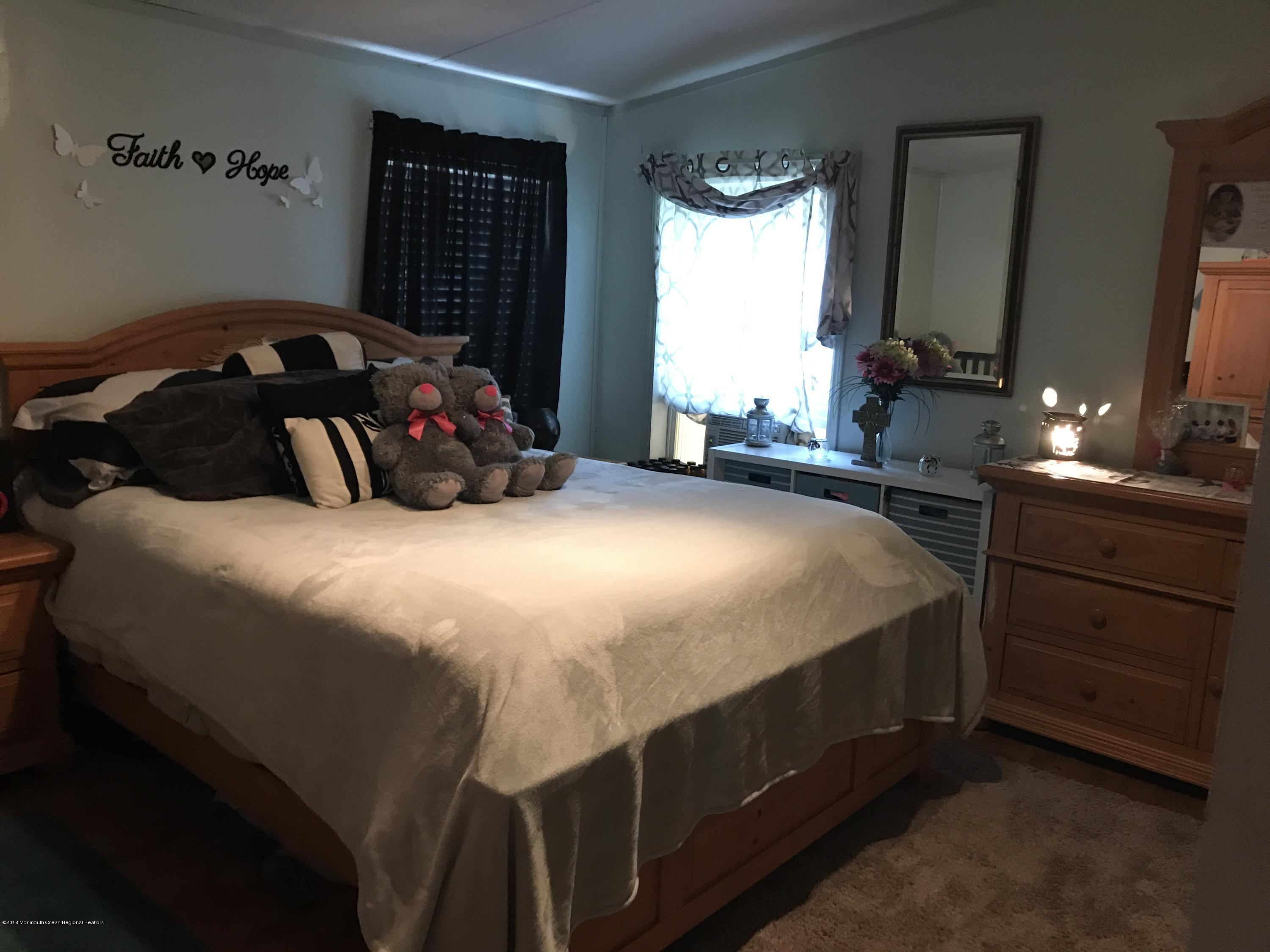 1272 Highway 36, Unit 39 Hazlet, NJ 07730 - Photo 7 of 13 a bedroom with a bed and a closet