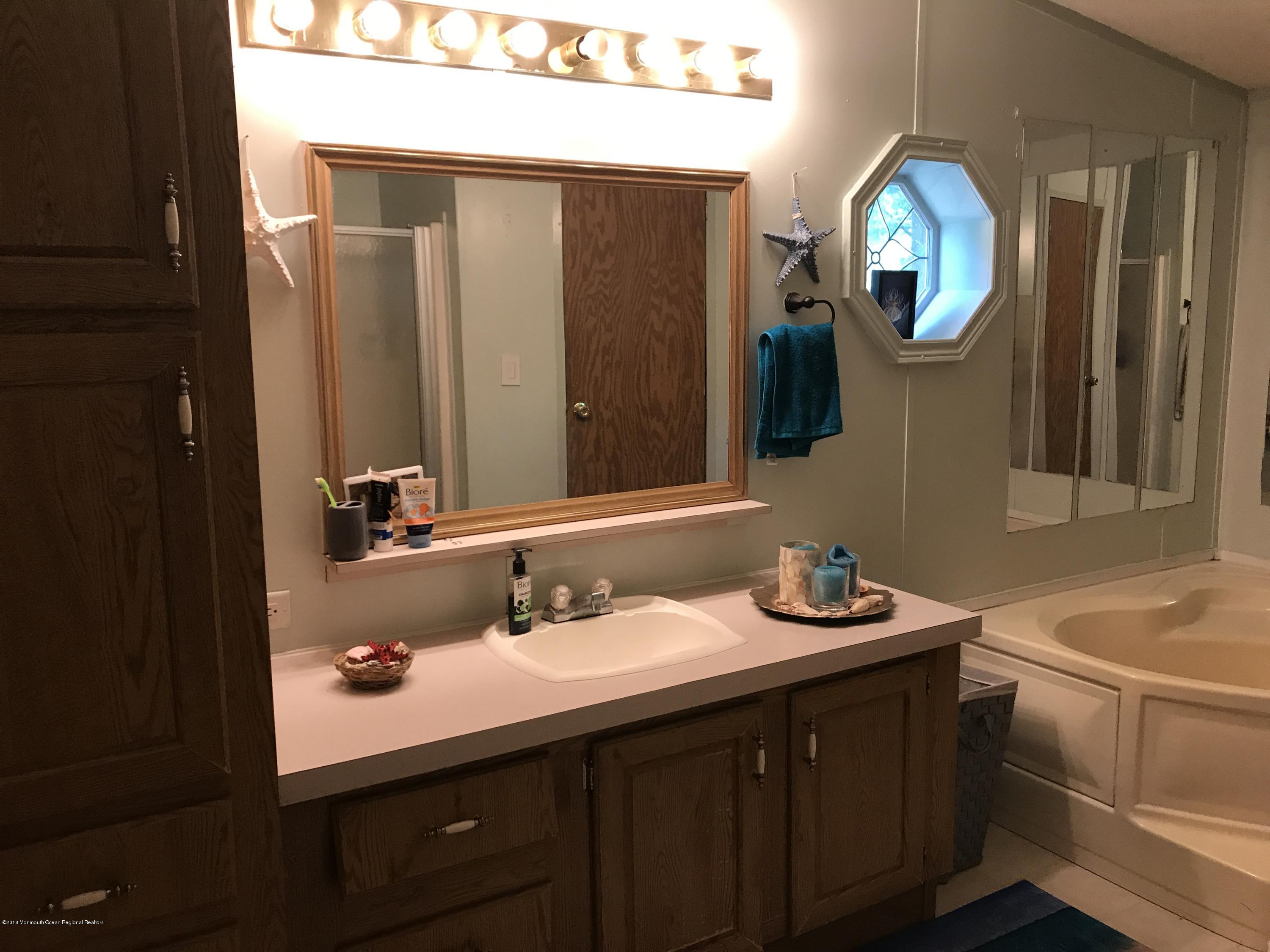 1272 Highway 36, Unit 39 Hazlet, NJ 07730 - Photo 8 of 13 a bathroom with a sink and a mirror