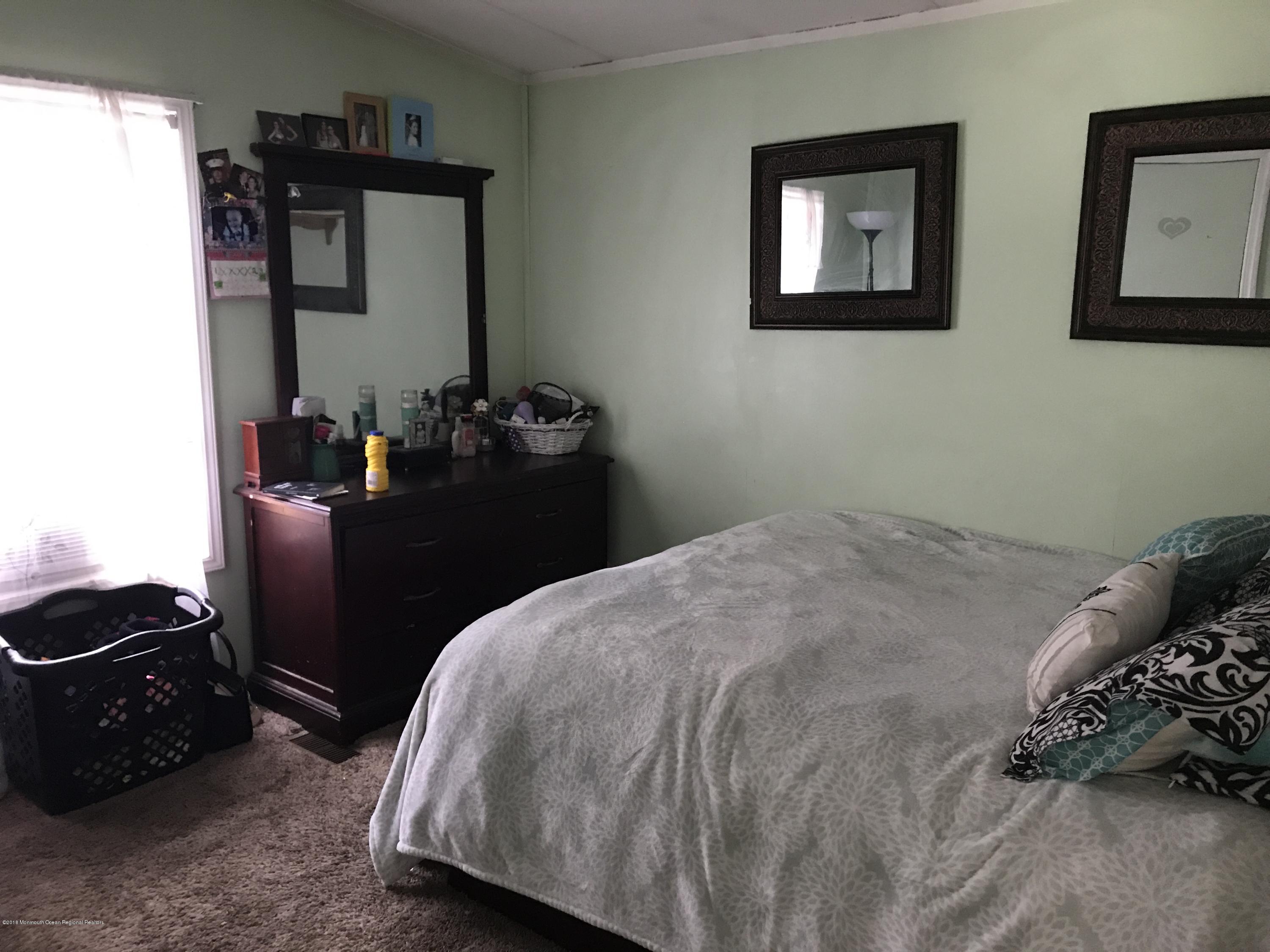 1272 Highway 36, Unit 39 Hazlet, NJ 07730 - Photo 9 of 13 a bedroom with bed and a closet