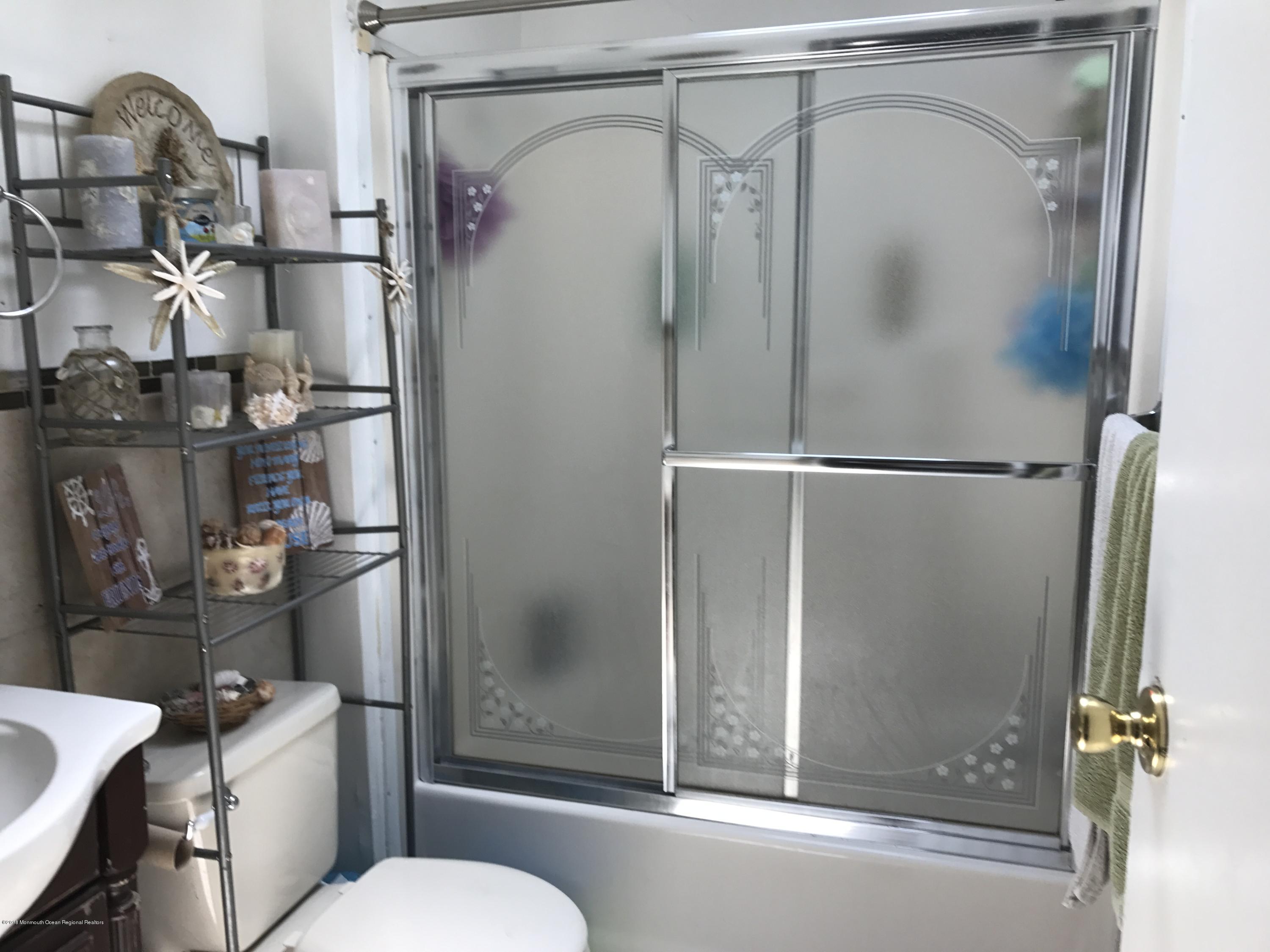 1272 Highway 36, Unit 39 Hazlet, NJ 07730 - Photo 10 of 13 a bathroom with a granite countertop bathtub shower sink mirror and toilet