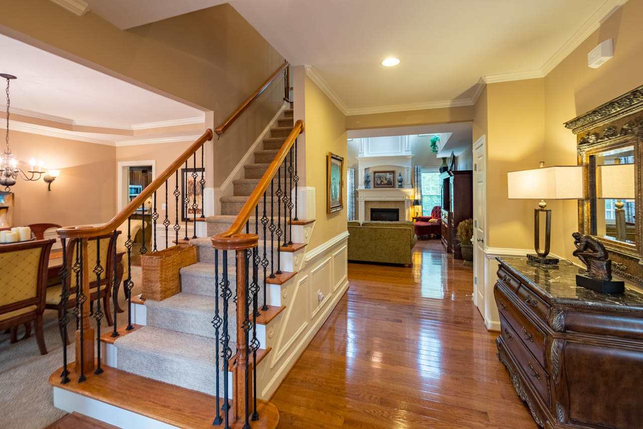 4445 Fairview Ridge Lane Apex, NC 27539 - Photo 3 of 30 Lovely wrought iron stair rails, hardwoods, and Study to the right. Dining room to the left. Entry foyer