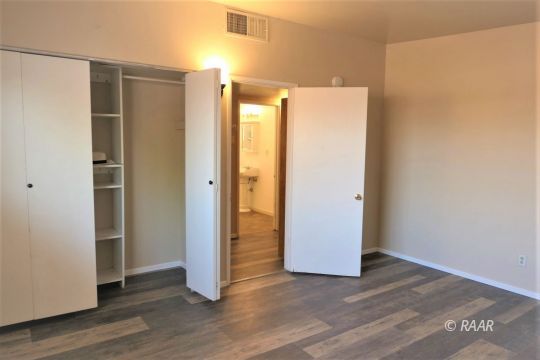 744 West Reeves Avenue Ridgecrest, CA 93555 - Photo 16 of 26 a view of an empty room with wooden floor and closet