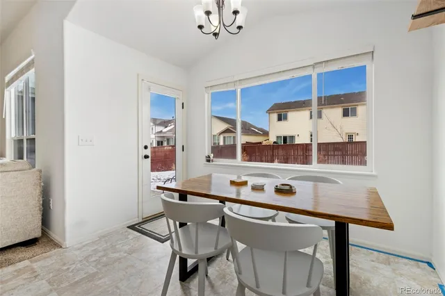 a kitchen with stainless steel appliances cabinets and table