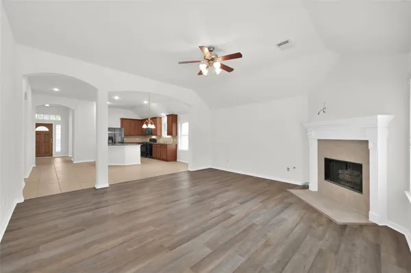 a view of a kitchen with a sink and a fireplace