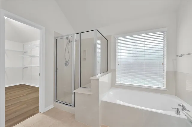 a bathroom with a shower and a bathtub
