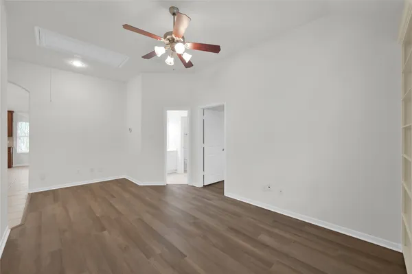 a view of an empty room with wooden floor