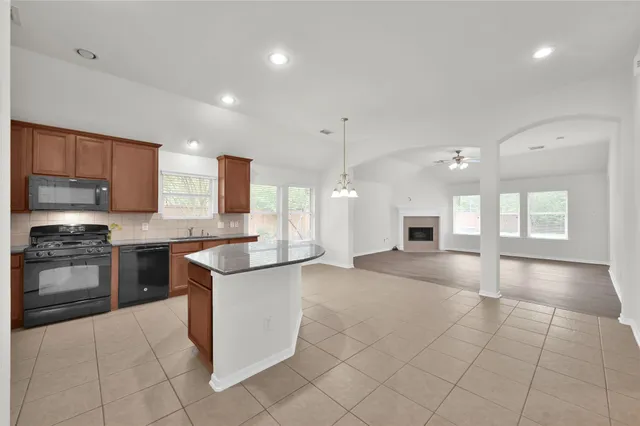 a kitchen with stainless steel appliances granite countertop a stove and a sink