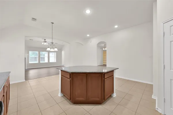 a kitchen with kitchen island a sink stainless steel appliances and cabinets