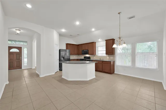 a kitchen with stainless steel appliances a refrigerator sink and microwave