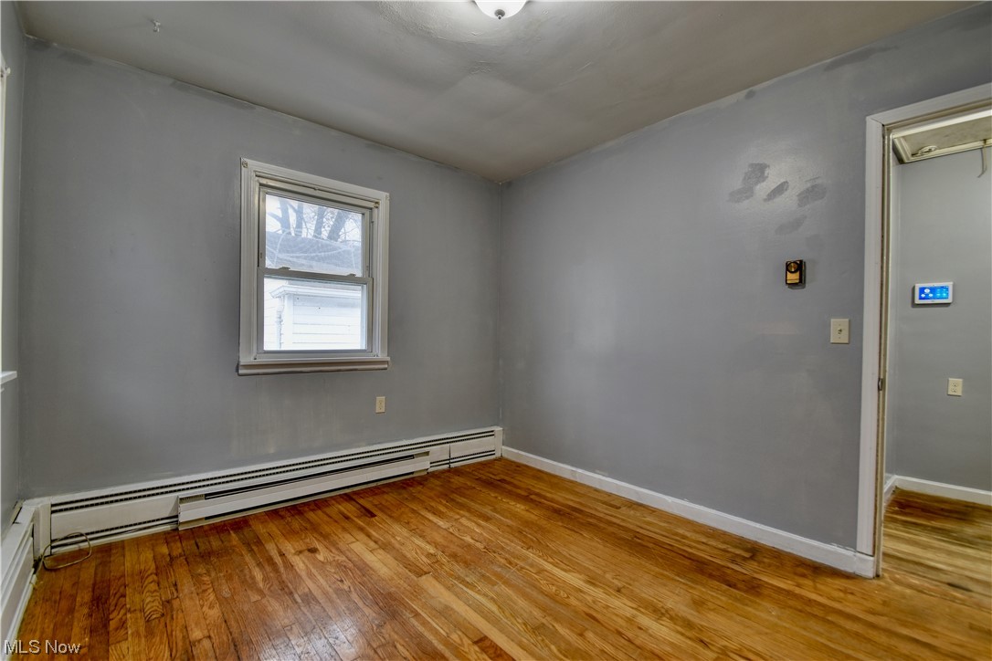 980 Reeve Road Elyria, OH 44035 - Photo 22 of 24 Unfurnished room with a baseboard heating unit and light hardwood / wood-style floors