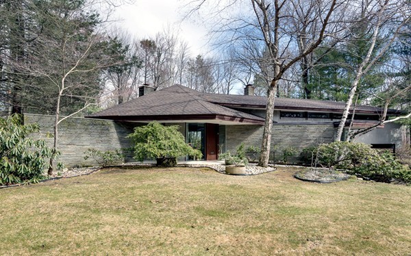64 Oak Hill Road Worcester, MA 01609 - Photo 23 of 23 a view of a patio with table and chairs under an umbrella with large trees