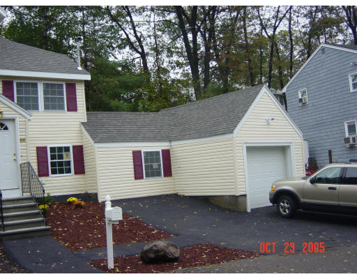 66 Springdale Avenue Saugus, MA 01906 - Photo 14 of 14 a view of a white house with a small yard and large tree