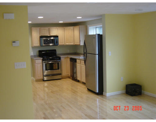 66 Springdale Avenue Saugus, MA 01906 - Photo 2 of 14 a kitchen with stainless steel appliances a refrigerator and a stove top oven