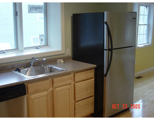 66 Springdale Avenue Saugus, MA 01906 - Photo 9 of 14 a kitchen with a sink and refrigerator