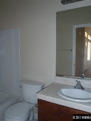 1547 Orca Way Reno, NV 89506 - Photo 12 of 13 a bathroom with a sink toilet and mirror