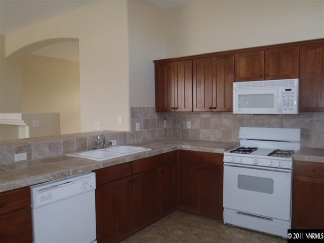 1547 Orca Way Reno, NV 89506 - Photo 8 of 13 a kitchen with a sink stove and cabinets