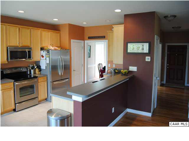 1370 Amber Ridge Road Charlottesville, VA 22901 - Photo 6 of 29 a kitchen with kitchen island granite countertop stainless steel appliances a stove refrigerator and microwave