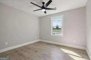 a view of a livingroom with a ceiling fan and window