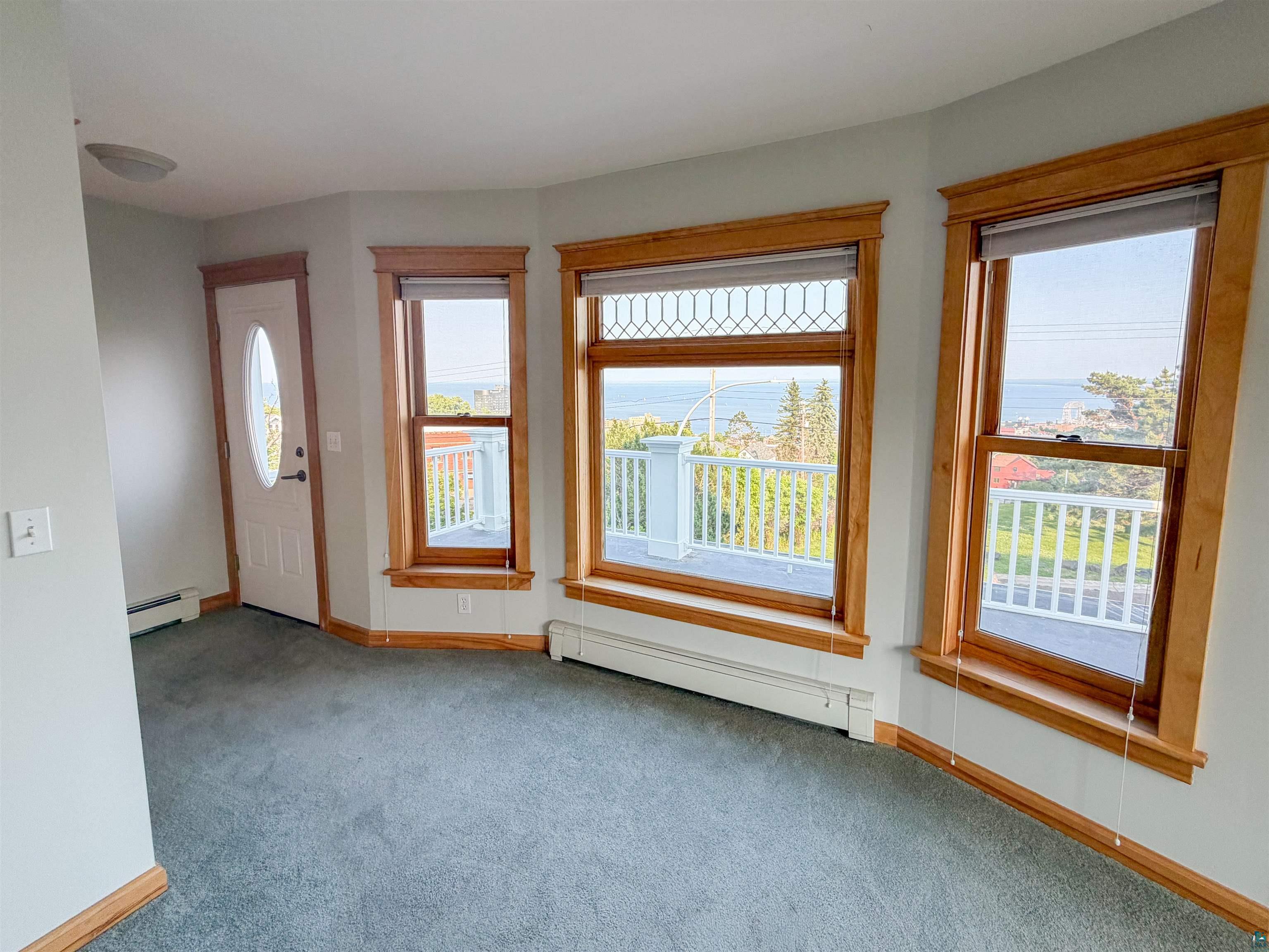 13 West 8th Street Duluth, MN 55806 - Photo 25 of 57 Bay window with natural wood trim, showcasing a water background