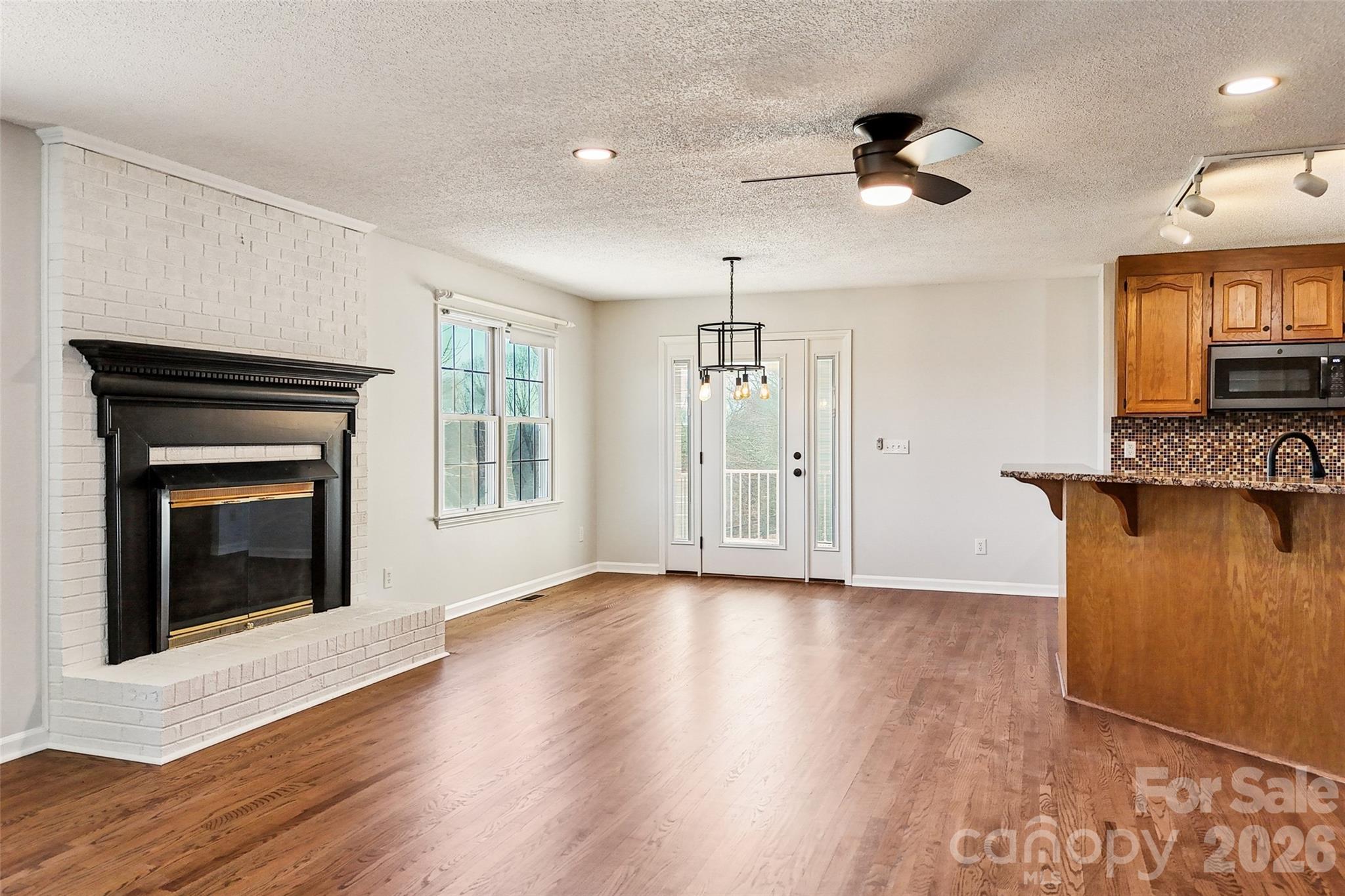 2034 New Prospect Church Road Shelby, NC 28150 - Photo 14 of 48 a view of an empty room with a fireplace and a window