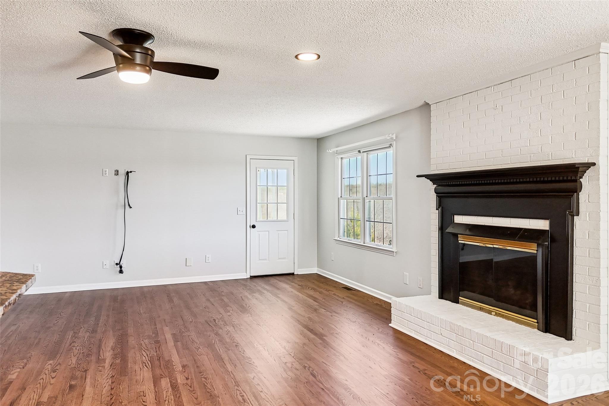 2034 New Prospect Church Road Shelby, NC 28150 - Photo 15 of 48 a living room with a fireplace furniture a ceiling fan and a rug