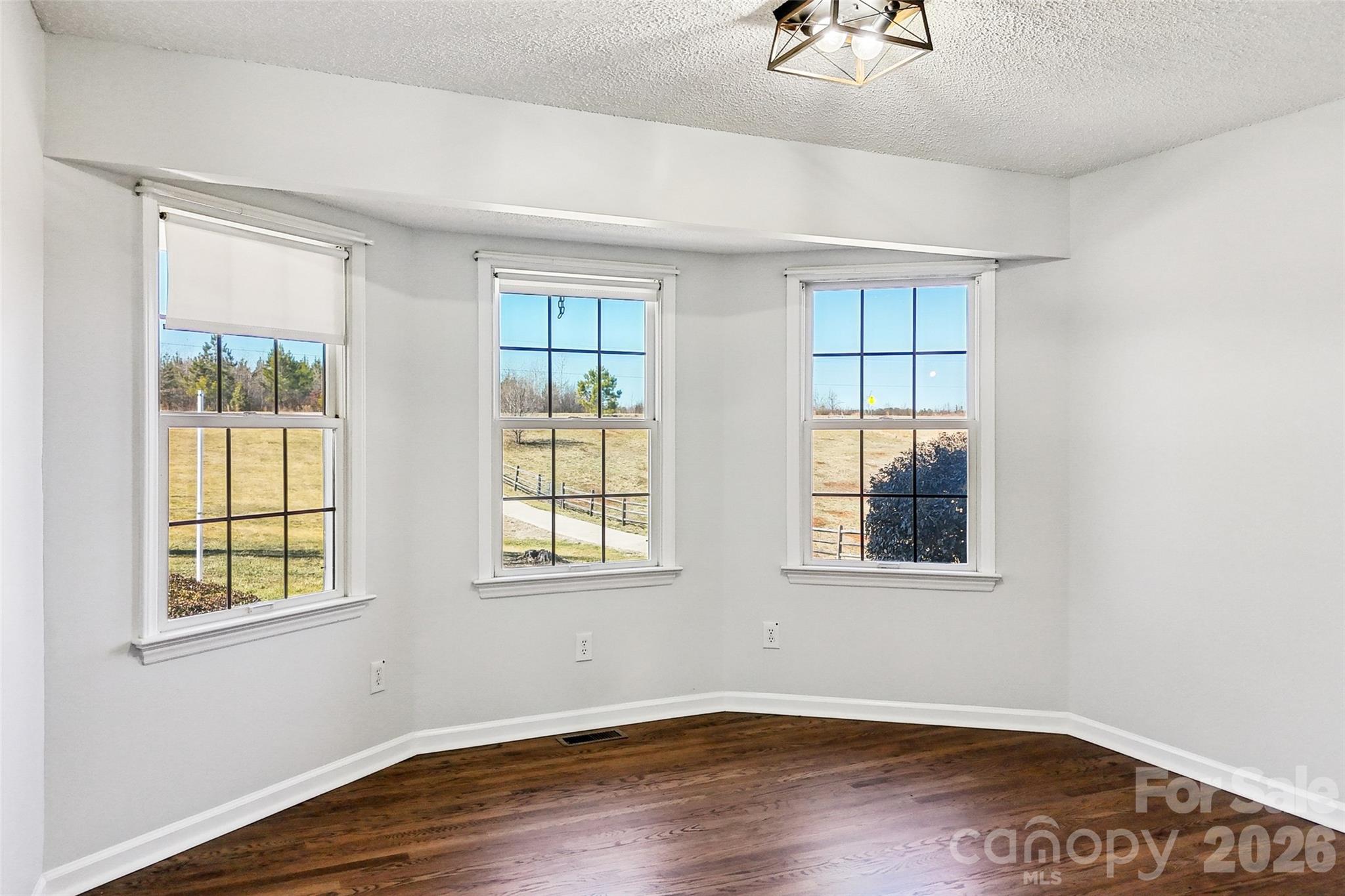 2034 New Prospect Church Road Shelby, NC 28150 - Photo 16 of 48 an empty room with wooden floor and windows