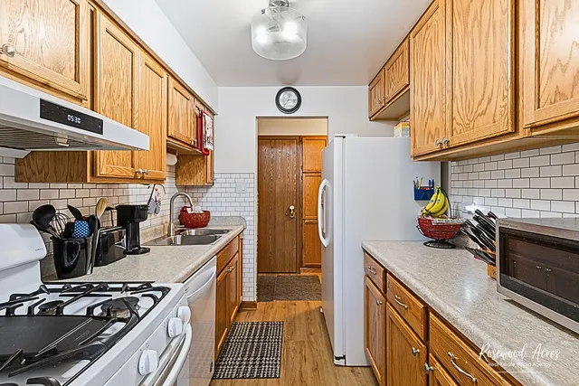 a kitchen with stainless steel appliances granite countertop a sink and cabinets