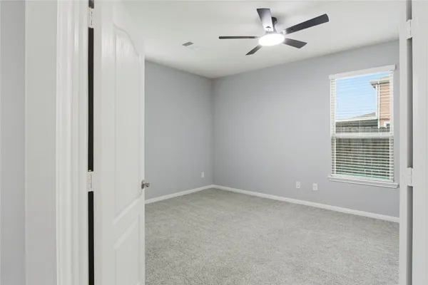 a view of an empty room with a window