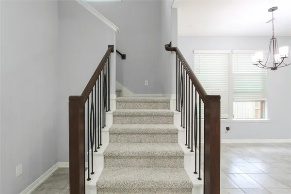 a view of staircase with white walls and windows