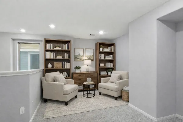 a living room with furniture and a book shelf