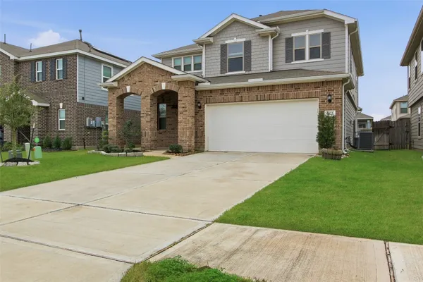 a front view of a house with a yard and garage