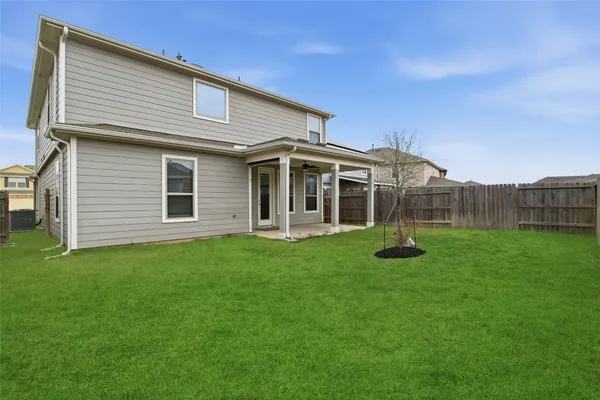 a view of a house with a backyard