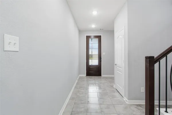 a view of hallway with a window and a kitchen