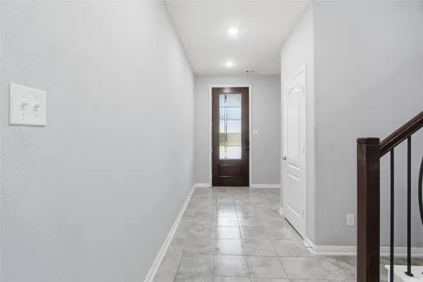 a view of hallway with a window and a kitchen