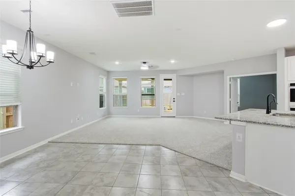 a view of an empty room with a chandelier