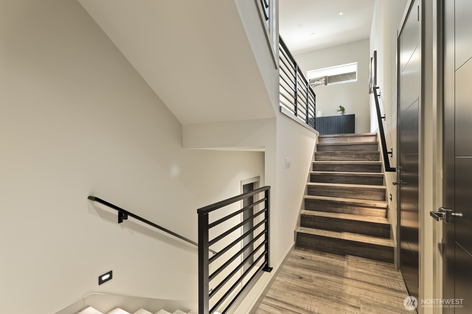 5009 Ocean Avenue Everett, WA 98203 - Photo 28 of 40 a view of a hallway with wooden floor and stairs