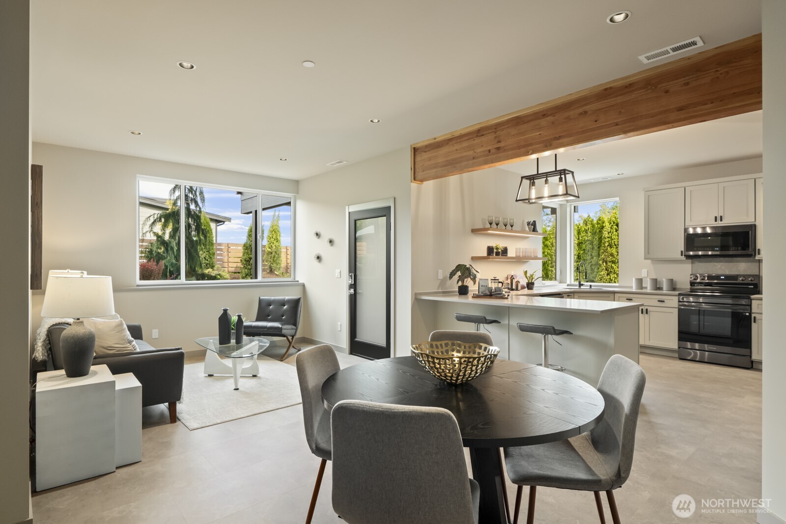 5009 Ocean Avenue Everett, WA 98203 - Photo 31 of 40 a kitchen with a dining table chairs stainless steel appliances and cabinets