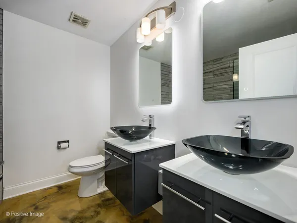 a kitchen with a sink a toilet and a mirror