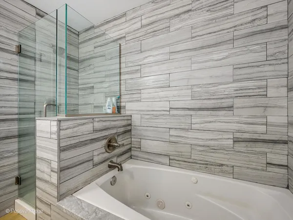 a bathroom with a bathtub and shower