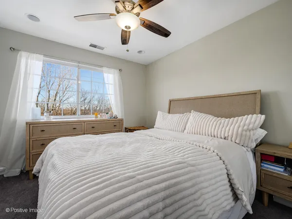 a bedroom with a large bed and a large window