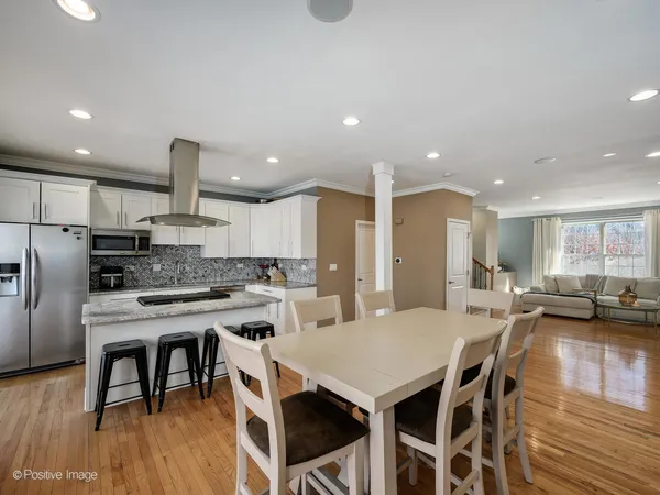 a large kitchen with a table and chairs