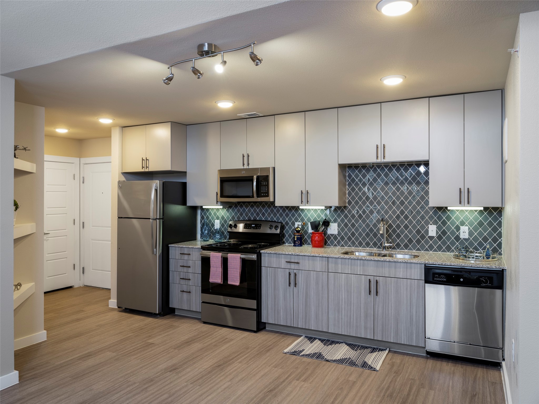 1800 South Interstate 35 Frontage Road Austin, TX 78704 - Photo 1 of 36 a kitchen with stainless steel appliances kitchen island granite countertop a refrigerator and a stove top oven